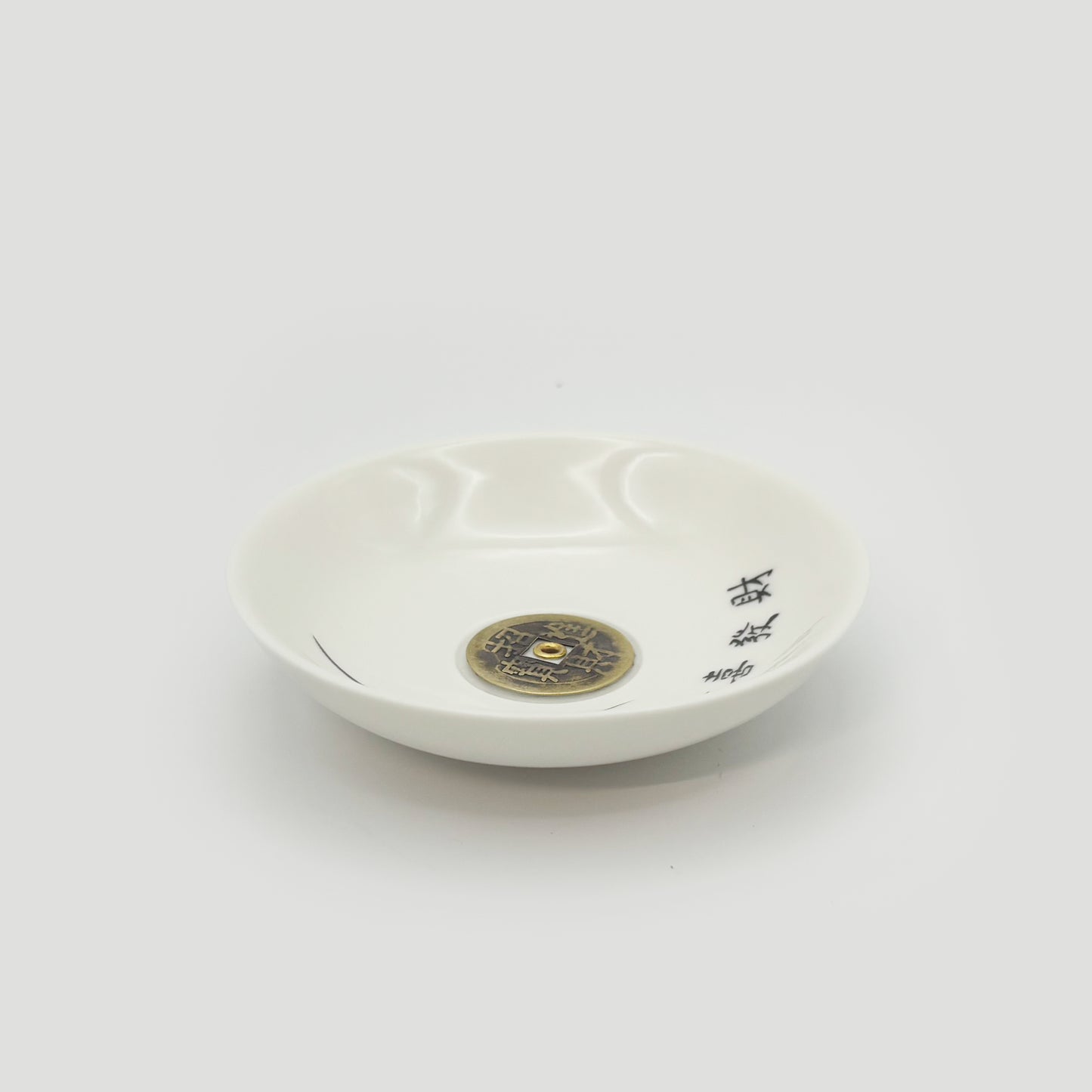 Side angle of the ceramic incense holder showing elegant curvature