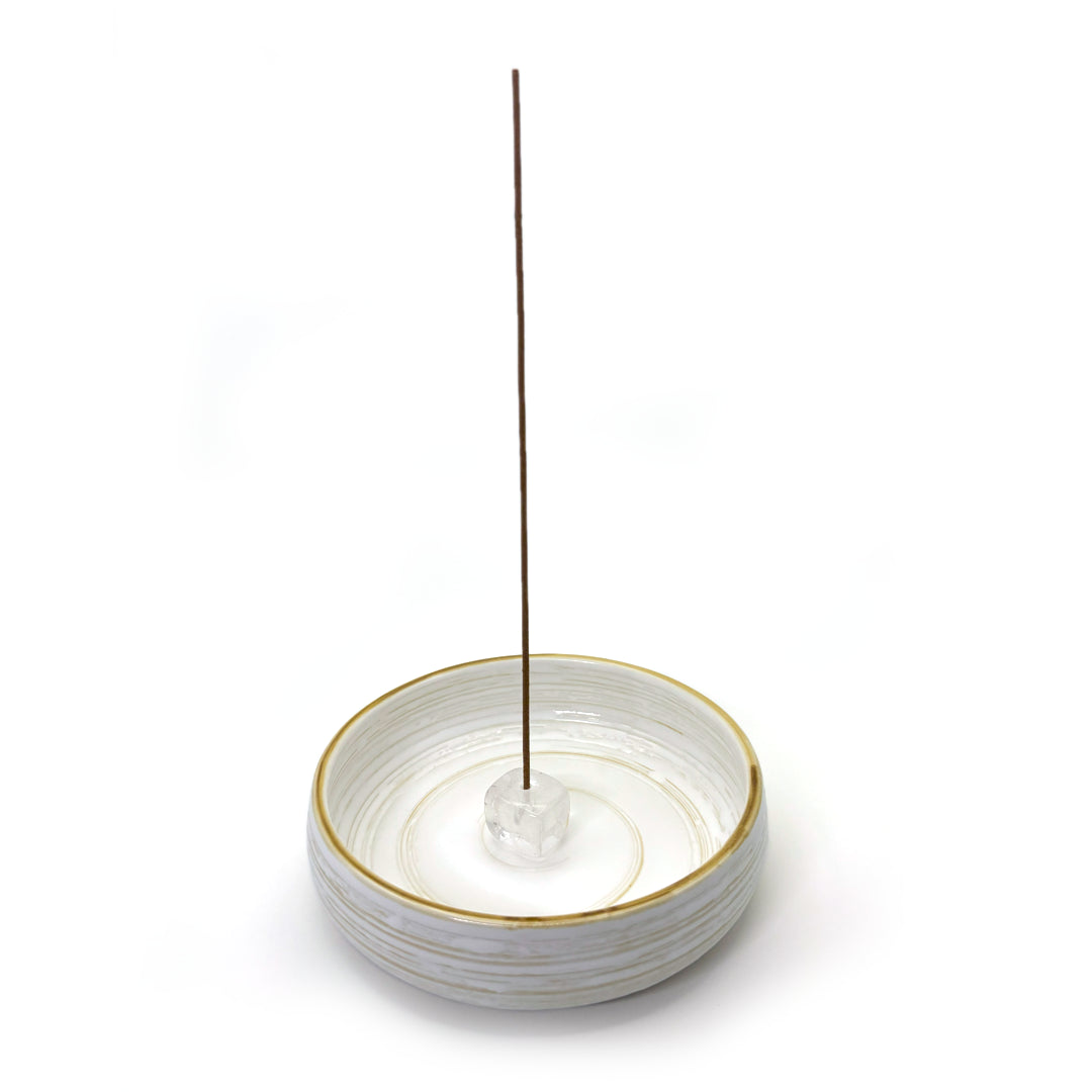 Clear quartz incense holder shown with ceramic base dish