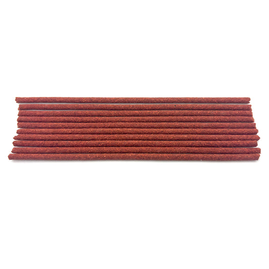 Close-up view of handcrafted Tibetan incense sticks – natural reddish color