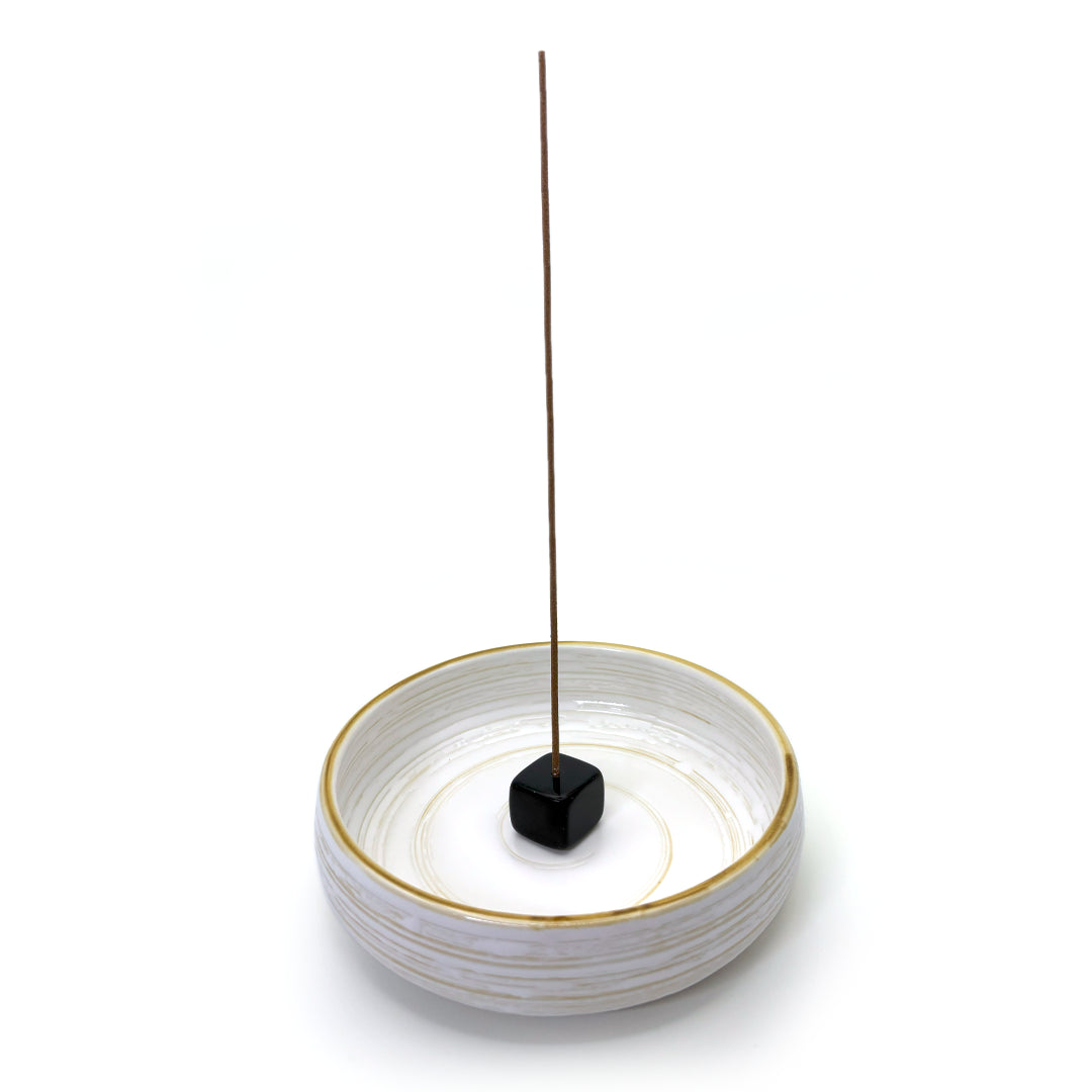 Obsidian crystal incense holder displayed with ceramic ash-catching dish