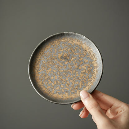 Close-up of rustic kiln-glazed ceramic base with golden speckles – Lamtong