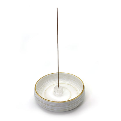 Clear quartz incense holder shown with ceramic base dish