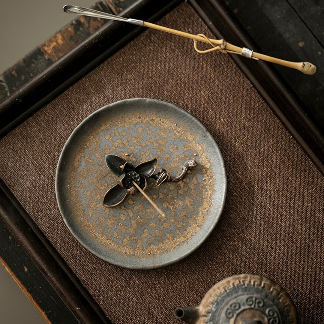 Top view of handmade gilded ceramic incense holder on tea table – Lamtong