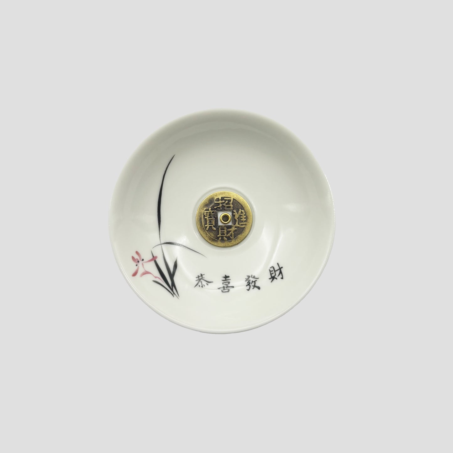 Top view of ceramic incense holder with Chinese coin design