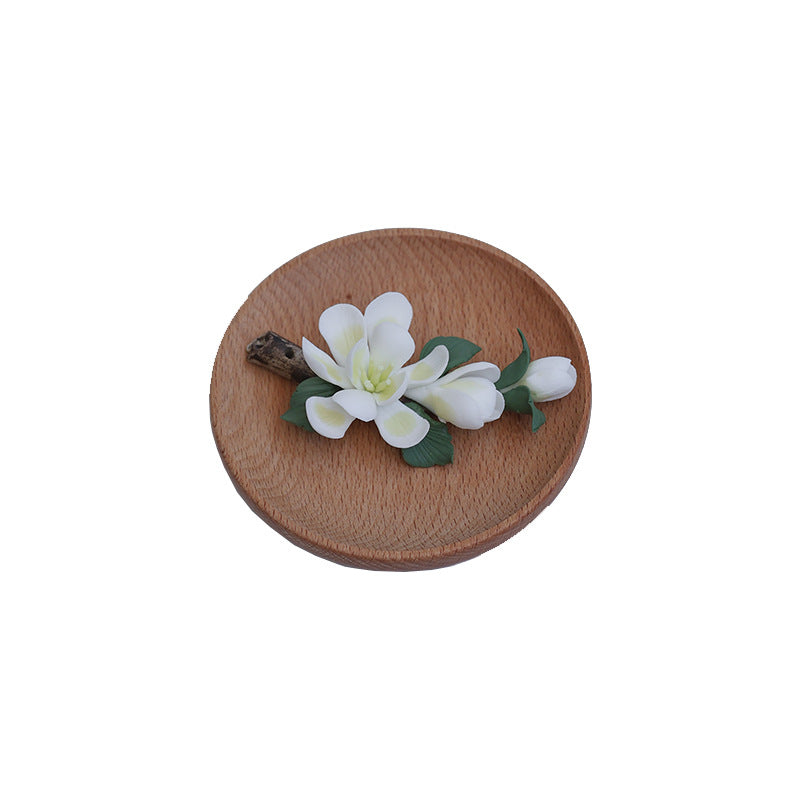 Top view of handmade ceramic magnolia incense holder on wooden base – minimalist zen decor by Lamtong