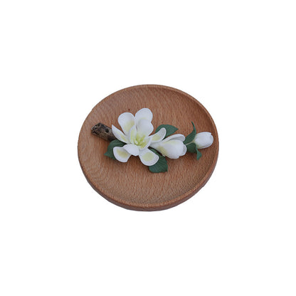 Top view of handmade ceramic magnolia incense holder on wooden base – minimalist zen decor by Lamtong