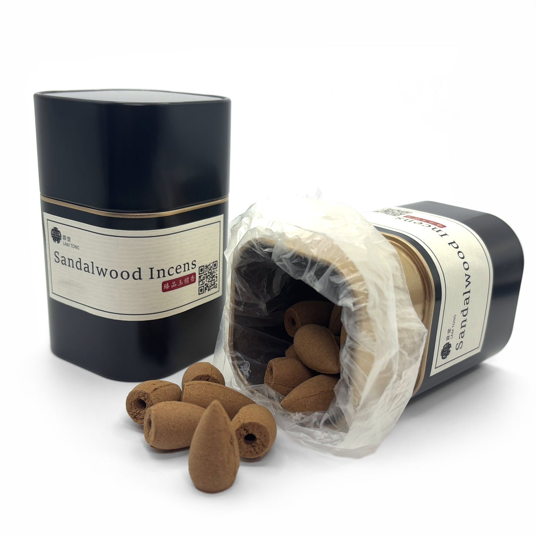 Sandalwood incense cones and red cylindrical storage tin
